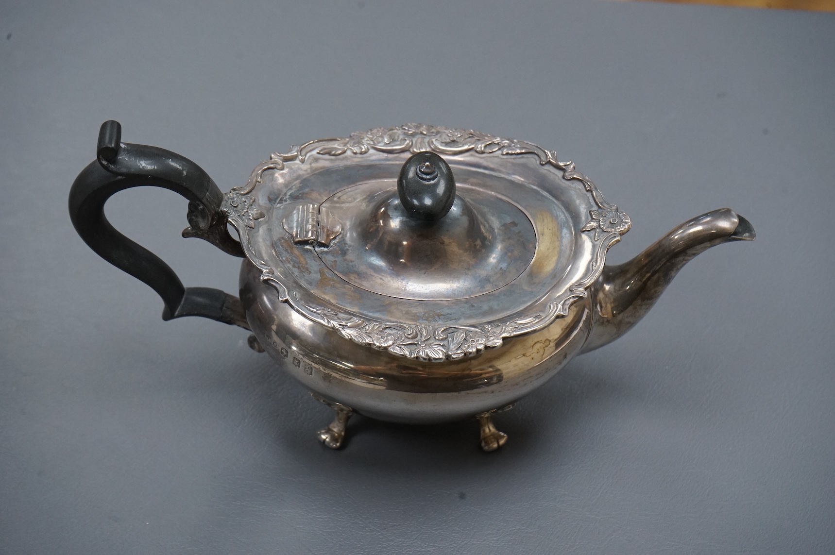 An Edwardian Scottish silver three piece oval tea set by Weir & Sons, Glasgow, 1901, gross 25.5oz, with foliate borders.